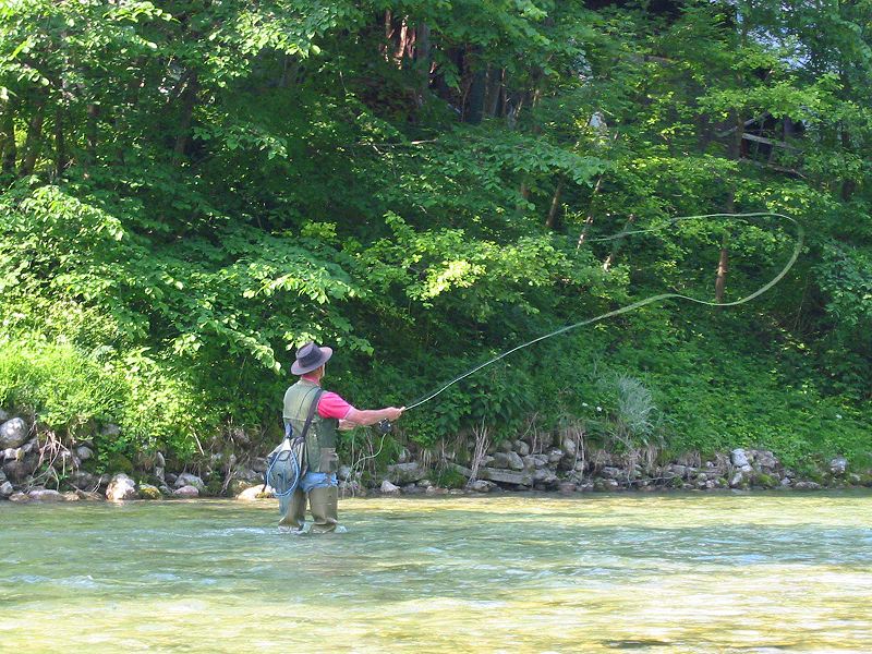 Cabin guest fly fishing for trout on the Upper Mt Fork River, just a short drive from our rental cabins in Oklahoma
