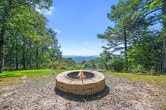 View of fire pit outside the Sunrise Cabin at Peckerwood Knob Cabin Rental in Oklahoma