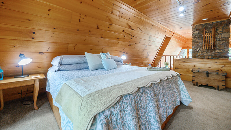 Master bedroom suite with its private patio with an amazing view of the Oklahoma sunrise makes Peckerwood Knob Cabins in Oklahoma the perfect retreat from everything destination.