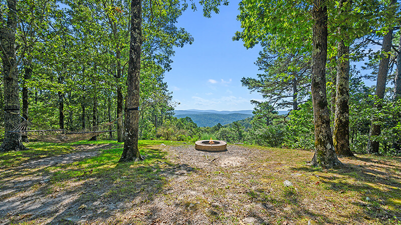 Hammock and Fire Pit with a view of the Ouachita Mountains make the Sunrise Cabin at Peckerwood Knob truly a unique family vacation destination.