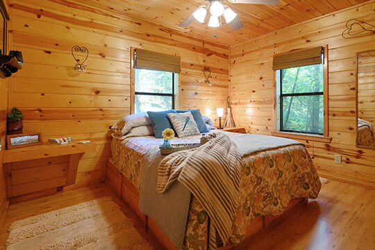 Comfortable, cozy, and rustic bedroom in the Sunset Cabin at Peckerwood Knob Cabins in Oklahoma