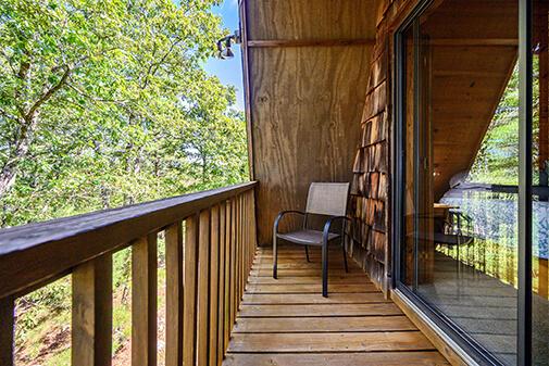 Just outside your master bedroom suite there is a private patio for you to enjoy the mornings during your stay at the Sunrise Cabin at Peckerwood Knob Oklahoma Cabin Rentals