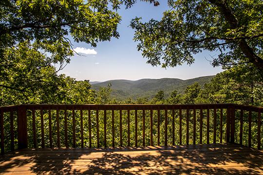 The Kiamichi Mountains surround your view from the Sunset Cabin deck